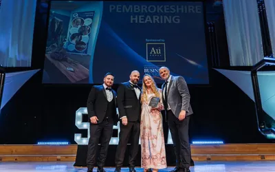 The Pembrokeshire Hearing team on stage at the Swansea Bay Business Awards 2025