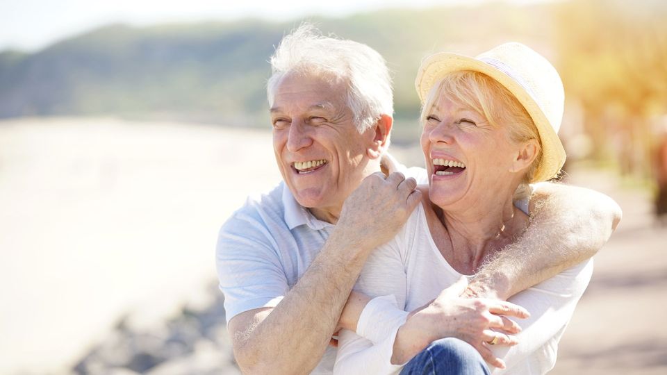 An older couple laughing together on the Pembrokeshire coast